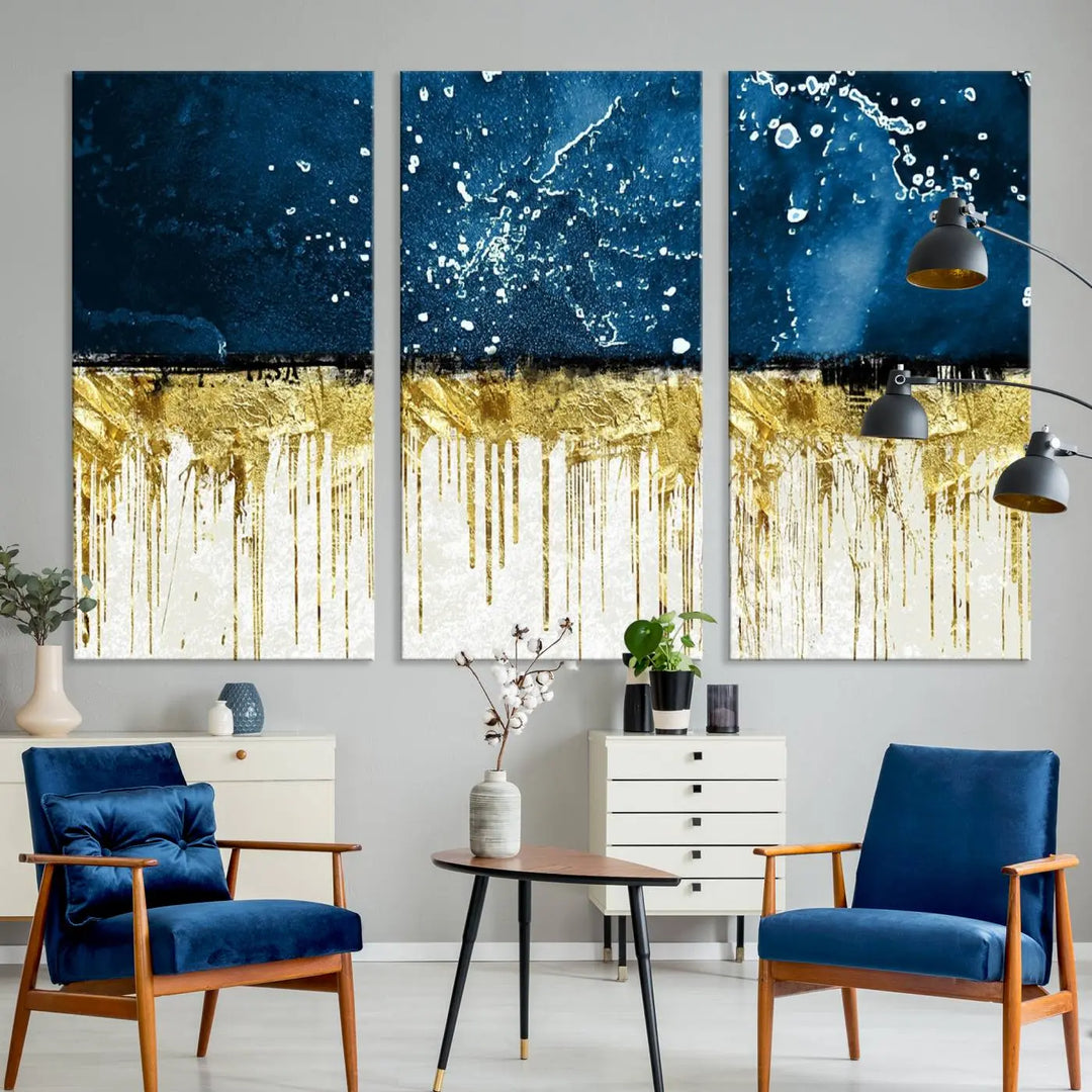 The Navy Blue Marble Fluid Effect Wall Art Abstract Canvas Print, a three-panel piece featuring blue, gold, and white colors on gallery-wrapped canvas, adorns the wall in a modern room. The museum-quality canvas ensures an elegant touch.