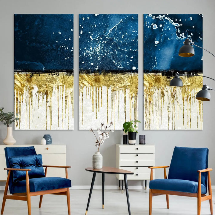 The Navy Blue Marble Fluid Effect Wall Art Abstract Canvas Print, a three-panel piece featuring blue, gold, and white colors on gallery-wrapped canvas, adorns the wall in a modern room. The museum-quality canvas ensures an elegant touch.