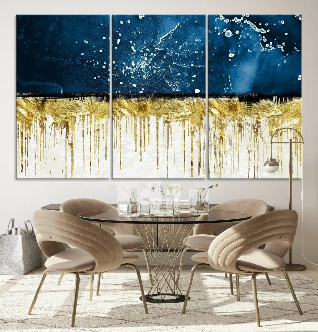 The Navy Blue Marble Fluid Effect Wall Art Abstract Canvas Print, a three-panel piece featuring blue, gold, and white colors on gallery-wrapped canvas, adorns the wall in a modern room. The museum-quality canvas ensures an elegant touch.