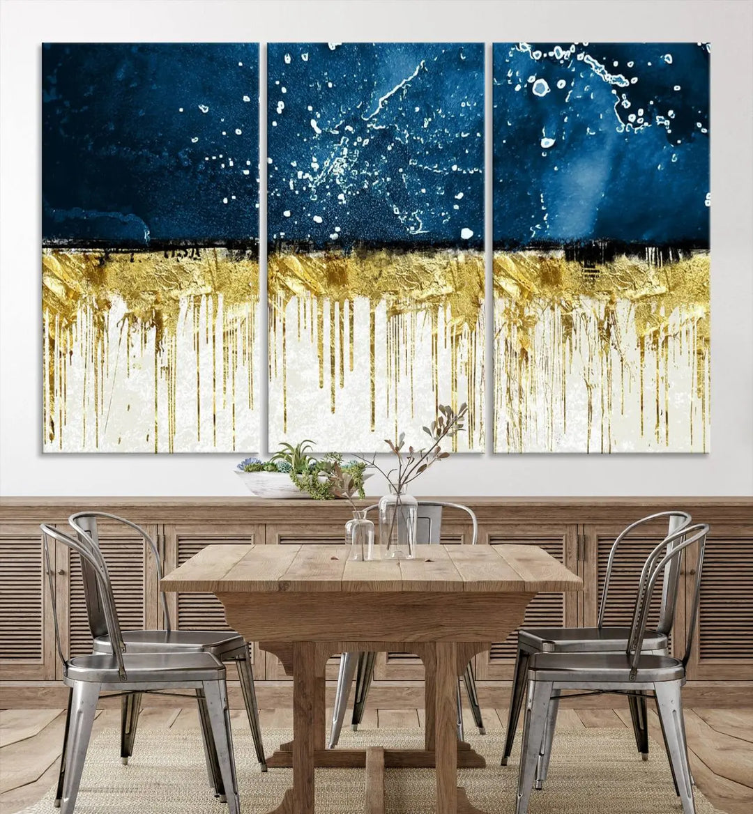 The Navy Blue Marble Fluid Effect Wall Art Abstract Canvas Print, a three-panel piece featuring blue, gold, and white colors on gallery-wrapped canvas, adorns the wall in a modern room. The museum-quality canvas ensures an elegant touch.