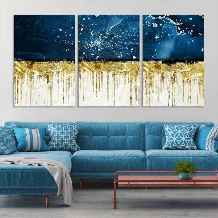 The Navy Blue Marble Fluid Effect Wall Art Abstract Canvas Print, a three-panel piece featuring blue, gold, and white colors on gallery-wrapped canvas, adorns the wall in a modern room. The museum-quality canvas ensures an elegant touch.