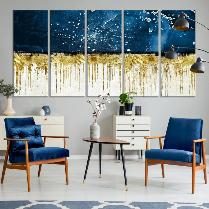 The Navy Blue Marble Fluid Effect Wall Art Abstract Canvas Print, a three-panel piece featuring blue, gold, and white colors on gallery-wrapped canvas, adorns the wall in a modern room. The museum-quality canvas ensures an elegant touch.