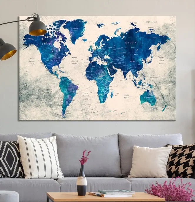 A Navy Blue Push Pin World Map Wall Art Canvas Print, displayed as a triptych on gallery-wrapped, museum-quality canvas, hangs on the wall.