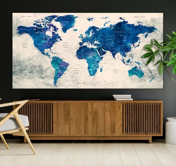 A Navy Blue Push Pin World Map Wall Art Canvas Print, displayed as a triptych on gallery-wrapped, museum-quality canvas, hangs on the wall.