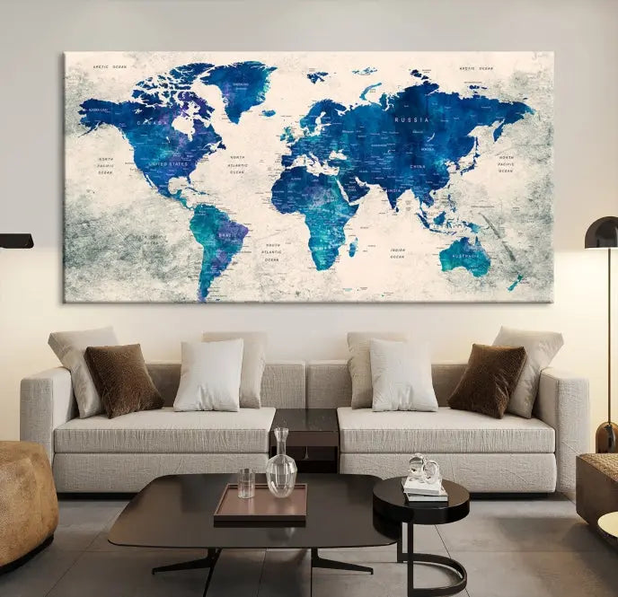 A Navy Blue Push Pin World Map Wall Art Canvas Print, displayed as a triptych on gallery-wrapped, museum-quality canvas, hangs on the wall.