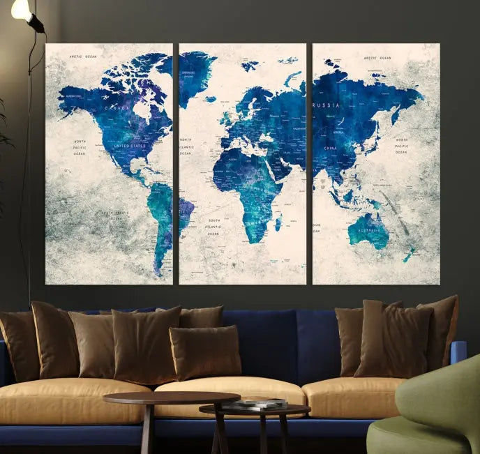 A Navy Blue Push Pin World Map Wall Art Canvas Print, displayed as a triptych on gallery-wrapped, museum-quality canvas, hangs on the wall.