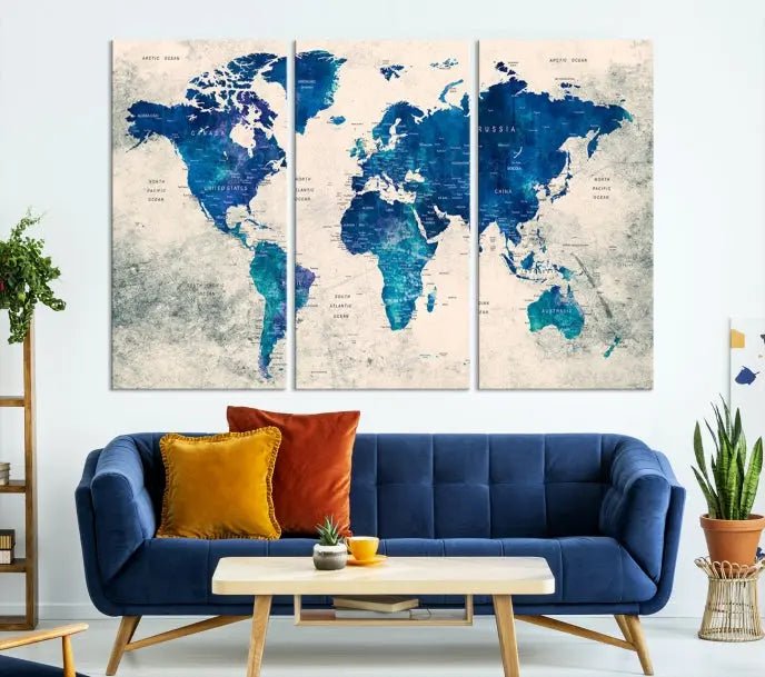 A Navy Blue Push Pin World Map Wall Art Canvas Print, displayed as a triptych on gallery-wrapped, museum-quality canvas, hangs on the wall.