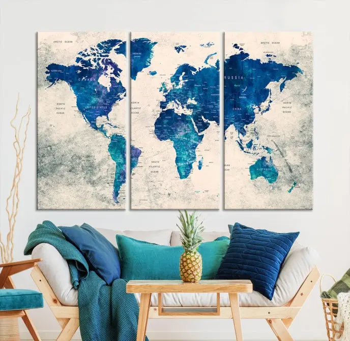 A Navy Blue Push Pin World Map Wall Art Canvas Print, displayed as a triptych on gallery-wrapped, museum-quality canvas, hangs on the wall.