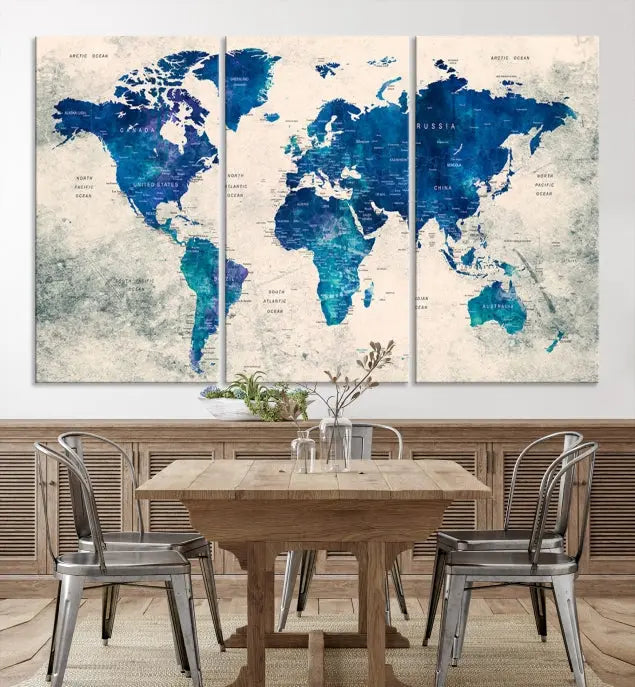 A Navy Blue Push Pin World Map Wall Art Canvas Print, displayed as a triptych on gallery-wrapped, museum-quality canvas, hangs on the wall.