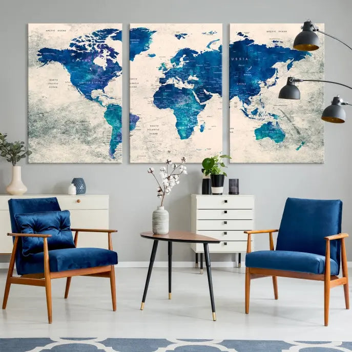 A Navy Blue Push Pin World Map Wall Art Canvas Print, displayed as a triptych on gallery-wrapped, museum-quality canvas, hangs on the wall.