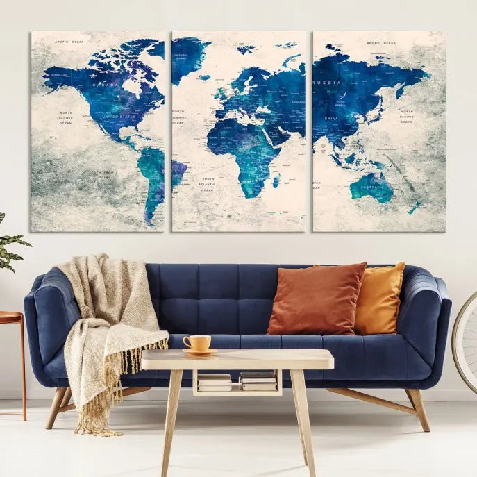 A Navy Blue Push Pin World Map Wall Art Canvas Print, displayed as a triptych on gallery-wrapped, museum-quality canvas, hangs on the wall.