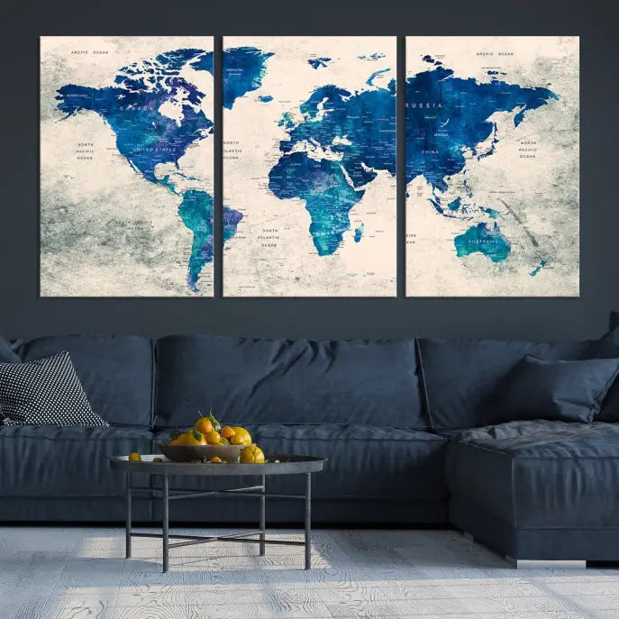 A Navy Blue Push Pin World Map Wall Art Canvas Print, displayed as a triptych on gallery-wrapped, museum-quality canvas, hangs on the wall.