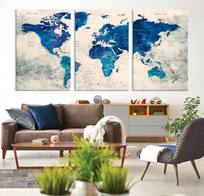 A Navy Blue Push Pin World Map Wall Art Canvas Print, displayed as a triptych on gallery-wrapped, museum-quality canvas, hangs on the wall.