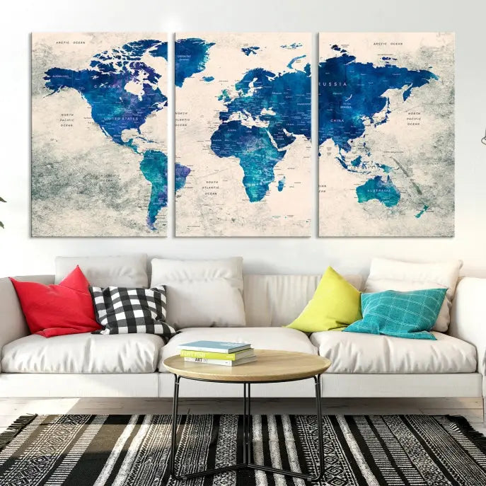 A Navy Blue Push Pin World Map Wall Art Canvas Print, displayed as a triptych on gallery-wrapped, museum-quality canvas, hangs on the wall.