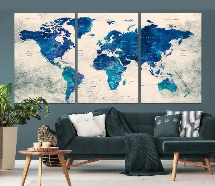 A Navy Blue Push Pin World Map Wall Art Canvas Print, displayed as a triptych on gallery-wrapped, museum-quality canvas, hangs on the wall.