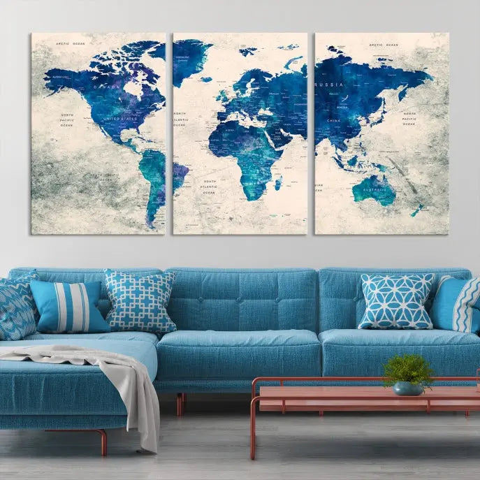 A Navy Blue Push Pin World Map Wall Art Canvas Print, displayed as a triptych on gallery-wrapped, museum-quality canvas, hangs on the wall.