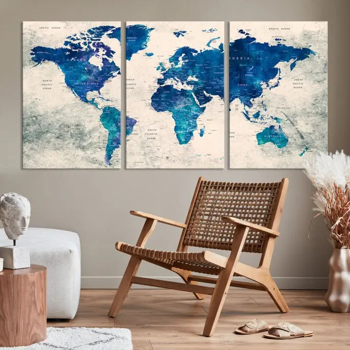 A Navy Blue Push Pin World Map Wall Art Canvas Print, displayed as a triptych on gallery-wrapped, museum-quality canvas, hangs on the wall.