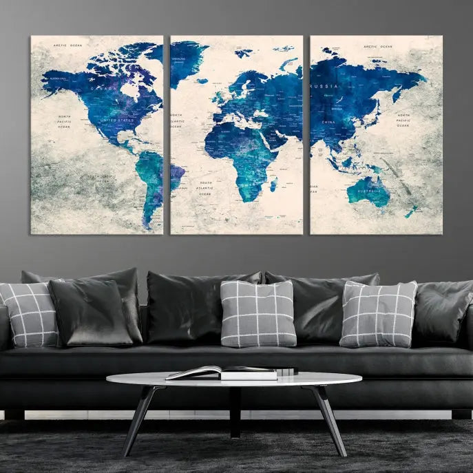 A Navy Blue Push Pin World Map Wall Art Canvas Print, displayed as a triptych on gallery-wrapped, museum-quality canvas, hangs on the wall.