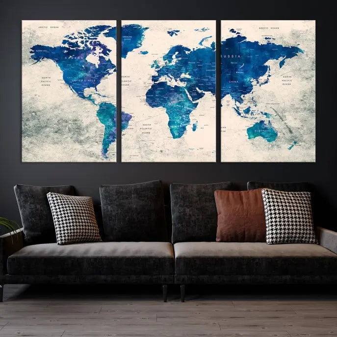 A Navy Blue Push Pin World Map Wall Art Canvas Print, displayed as a triptych on gallery-wrapped, museum-quality canvas, hangs on the wall.