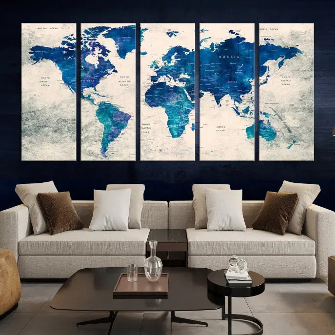 A Navy Blue Push Pin World Map Wall Art Canvas Print, displayed as a triptych on gallery-wrapped, museum-quality canvas, hangs on the wall.