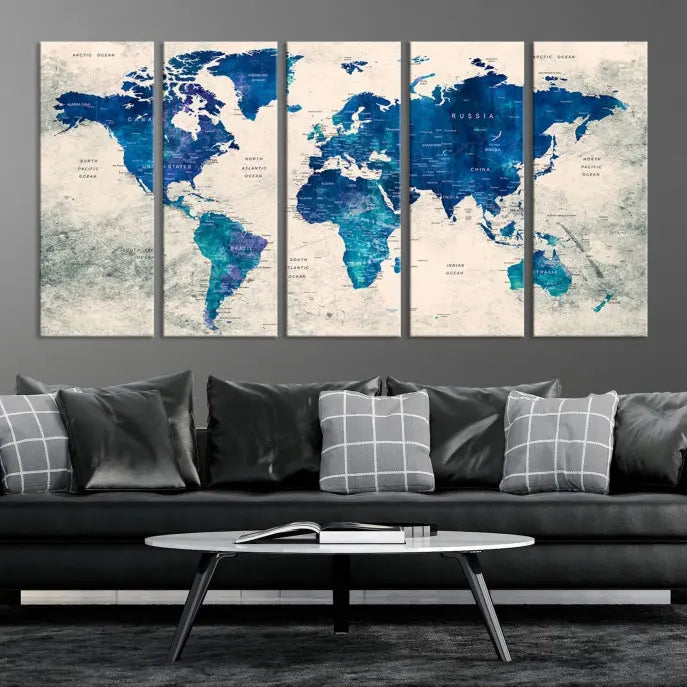 A Navy Blue Push Pin World Map Wall Art Canvas Print, displayed as a triptych on gallery-wrapped, museum-quality canvas, hangs on the wall.