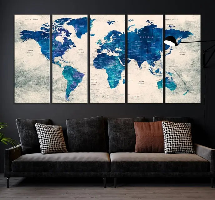 A Navy Blue Push Pin World Map Wall Art Canvas Print, displayed as a triptych on gallery-wrapped, museum-quality canvas, hangs on the wall.