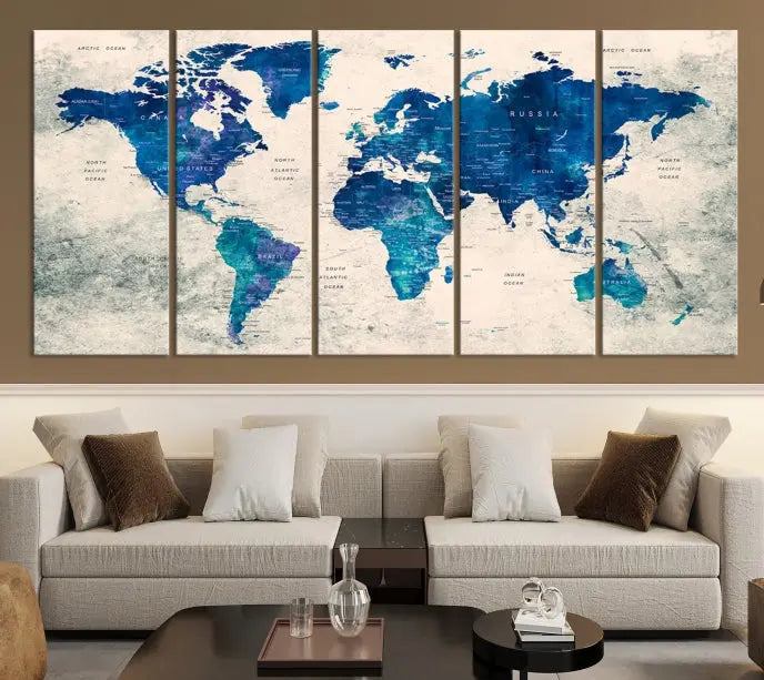 A Navy Blue Push Pin World Map Wall Art Canvas Print, displayed as a triptych on gallery-wrapped, museum-quality canvas, hangs on the wall.