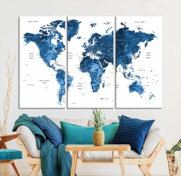 The Navy Blue Watercolor Push Pin World Map wall art canvas print, featuring a three-panel design and gallery wrapping on museum-quality canvas, adds an elegant touch to the room.