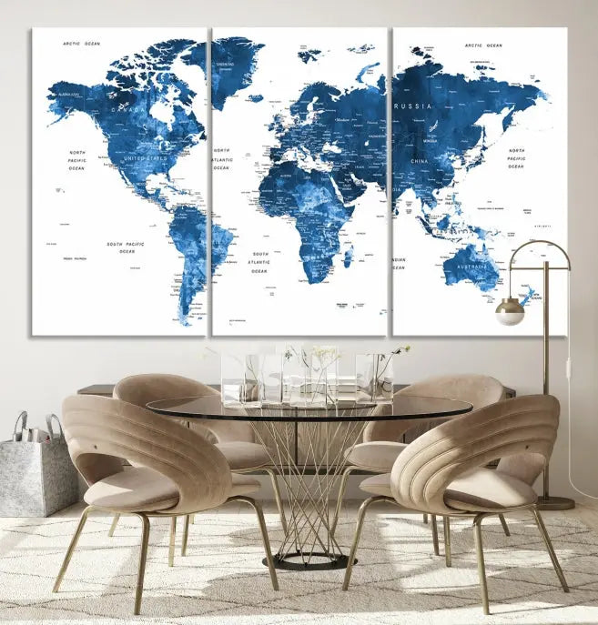 The Navy Blue Watercolor Push Pin World Map wall art canvas print, featuring a three-panel design and gallery wrapping on museum-quality canvas, adds an elegant touch to the room.