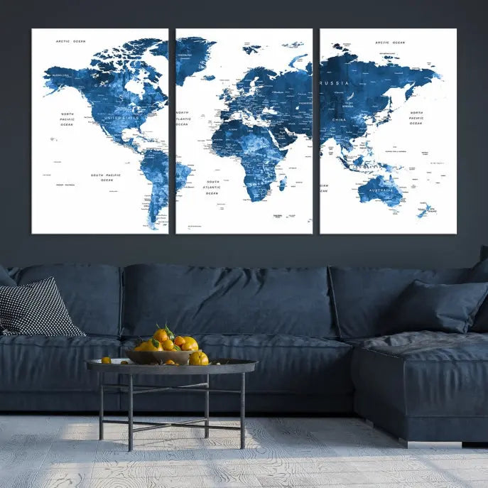 The Navy Blue Watercolor Push Pin World Map wall art canvas print, featuring a three-panel design and gallery wrapping on museum-quality canvas, adds an elegant touch to the room.