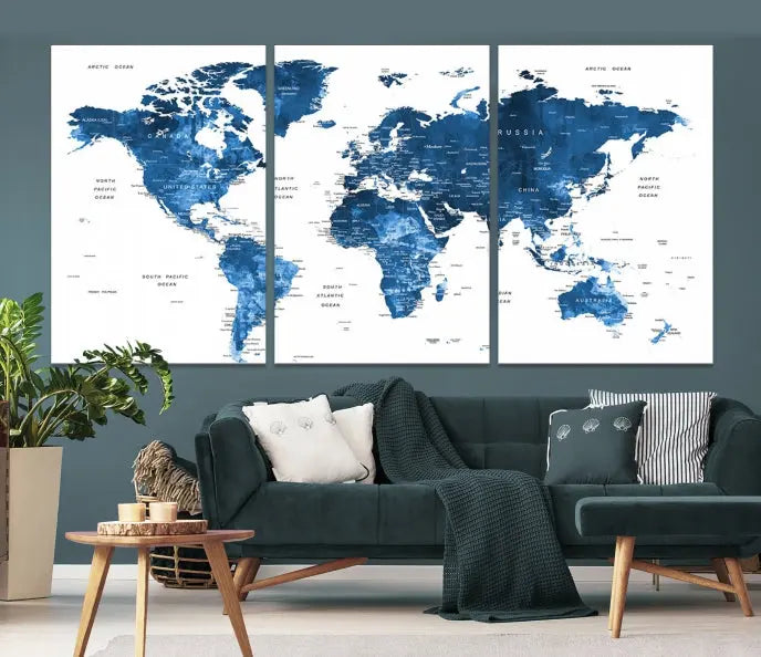 The Navy Blue Watercolor Push Pin World Map wall art canvas print, featuring a three-panel design and gallery wrapping on museum-quality canvas, adds an elegant touch to the room.