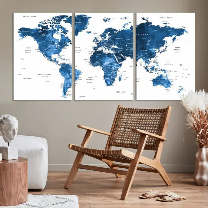 The Navy Blue Watercolor Push Pin World Map wall art canvas print, featuring a three-panel design and gallery wrapping on museum-quality canvas, adds an elegant touch to the room.