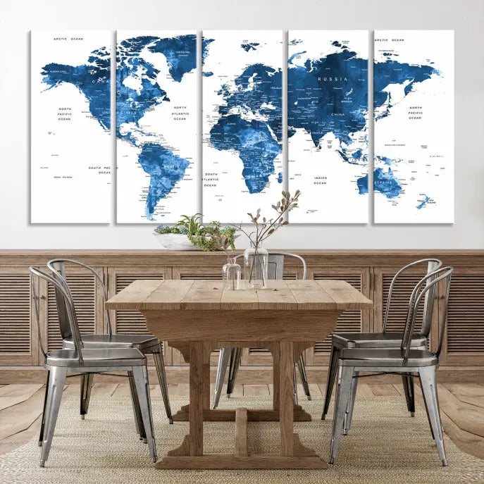 The Navy Blue Watercolor Push Pin World Map wall art canvas print, featuring a three-panel design and gallery wrapping on museum-quality canvas, adds an elegant touch to the room.