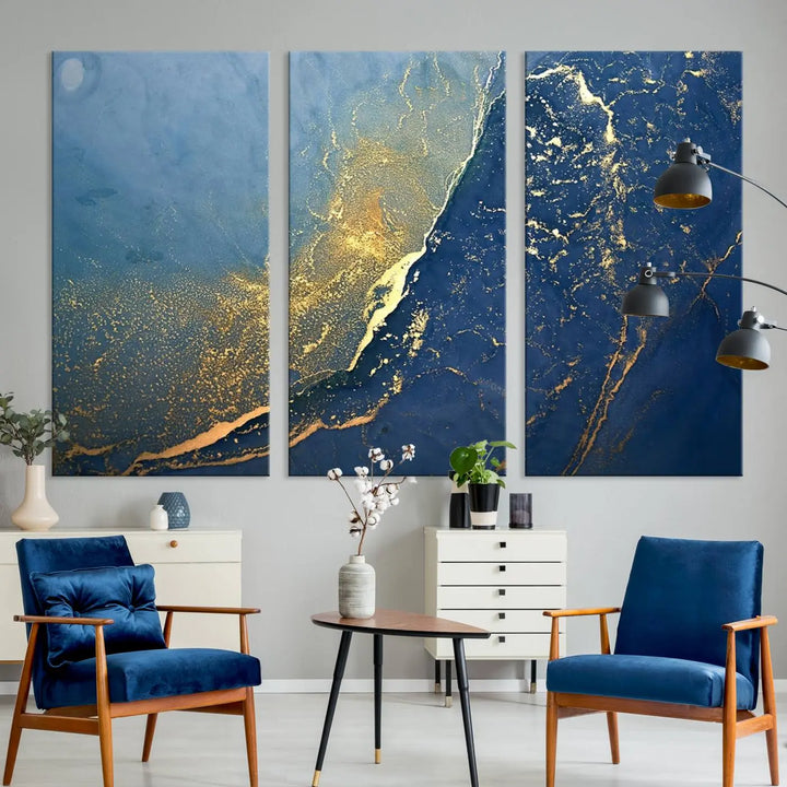 The Navy Blue Yellow Twinkle Wall Art Canvas Print, featuring an abstract design in gold and blue, enhances a modern living room as it adorns a white wall with its gallery-wrapped, museum-quality canvases for an exquisite touch.