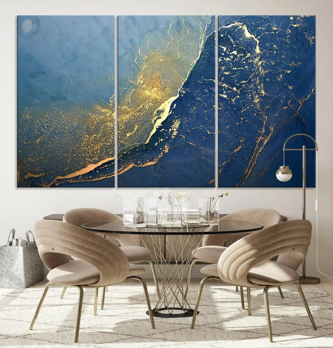 The Navy Blue Yellow Twinkle Wall Art Canvas Print, featuring an abstract design in gold and blue, enhances a modern living room as it adorns a white wall with its gallery-wrapped, museum-quality canvases for an exquisite touch.