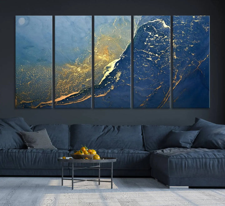 The Navy Blue Yellow Twinkle Wall Art Canvas Print, featuring an abstract design in gold and blue, enhances a modern living room as it adorns a white wall with its gallery-wrapped, museum-quality canvases for an exquisite touch.