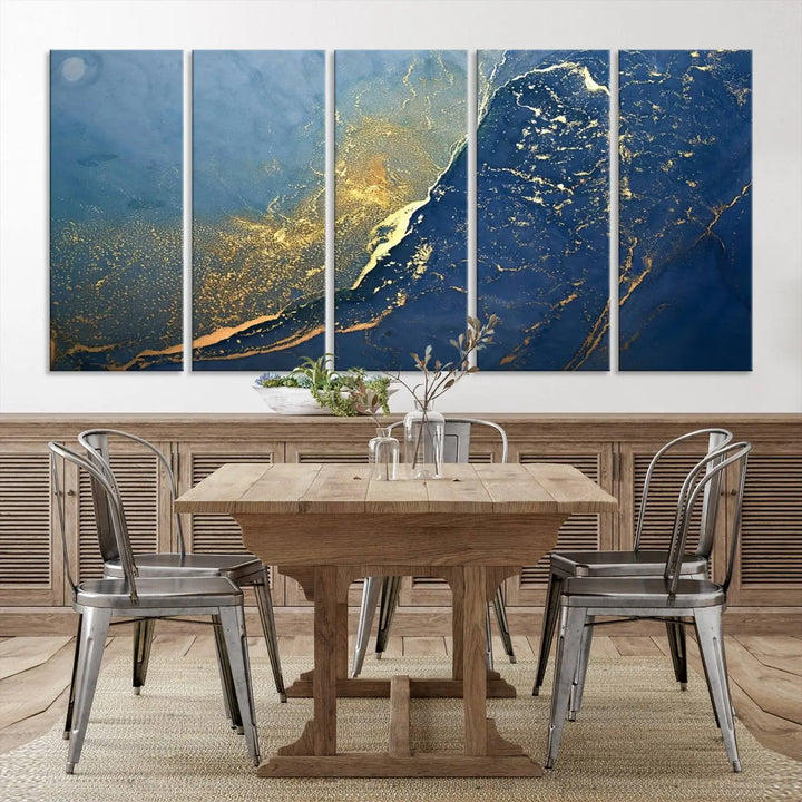 The Navy Blue Yellow Twinkle Wall Art Canvas Print, featuring an abstract design in gold and blue, enhances a modern living room as it adorns a white wall with its gallery-wrapped, museum-quality canvases for an exquisite touch.