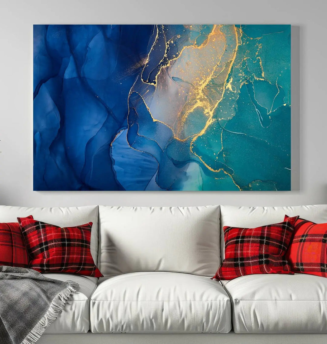 A Navy Blue and Green Marble Fluid Effect Wall Art Abstract Canvas Wall Art Print, featuring captivating patterns of blue and teal hues interlaced with gold veining, is ready to hang and protected by a UV-coating to preserve its vibrant colors over time.