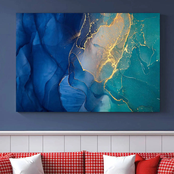 A Navy Blue and Green Marble Fluid Effect Wall Art Abstract Canvas Wall Art Print, featuring captivating patterns of blue and teal hues interlaced with gold veining, is ready to hang and protected by a UV-coating to preserve its vibrant colors over time.