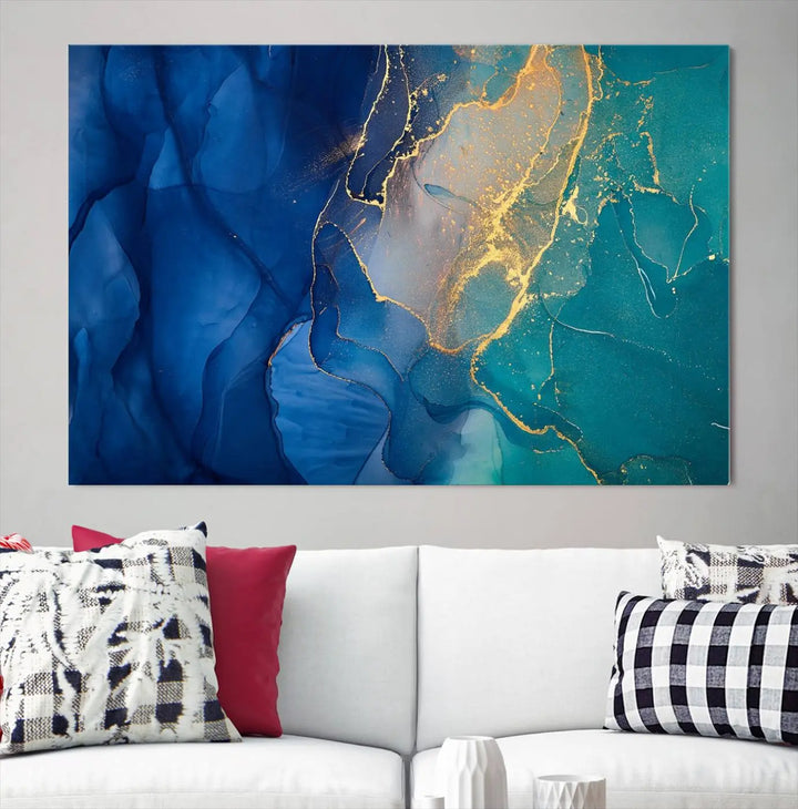 A Navy Blue and Green Marble Fluid Effect Wall Art Abstract Canvas Wall Art Print, featuring captivating patterns of blue and teal hues interlaced with gold veining, is ready to hang and protected by a UV-coating to preserve its vibrant colors over time.