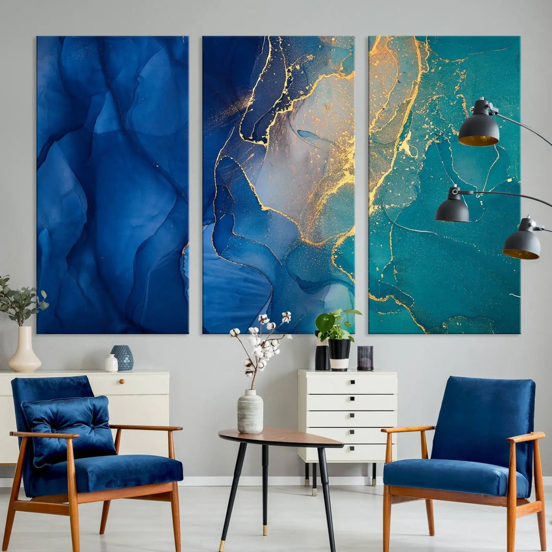 A Navy Blue and Green Marble Fluid Effect Wall Art Abstract Canvas Wall Art Print, featuring captivating patterns of blue and teal hues interlaced with gold veining, is ready to hang and protected by a UV-coating to preserve its vibrant colors over time.