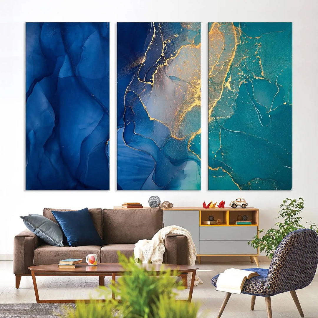 A Navy Blue and Green Marble Fluid Effect Wall Art Abstract Canvas Wall Art Print, featuring captivating patterns of blue and teal hues interlaced with gold veining, is ready to hang and protected by a UV-coating to preserve its vibrant colors over time.