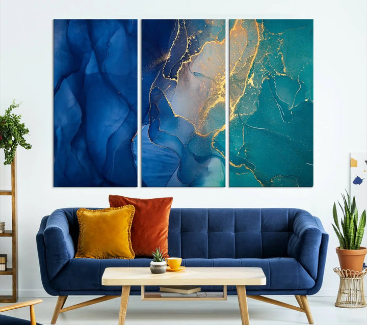 A Navy Blue and Green Marble Fluid Effect Wall Art Abstract Canvas Wall Art Print, featuring captivating patterns of blue and teal hues interlaced with gold veining, is ready to hang and protected by a UV-coating to preserve its vibrant colors over time.