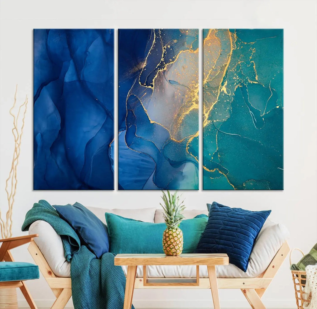 A Navy Blue and Green Marble Fluid Effect Wall Art Abstract Canvas Wall Art Print, featuring captivating patterns of blue and teal hues interlaced with gold veining, is ready to hang and protected by a UV-coating to preserve its vibrant colors over time.