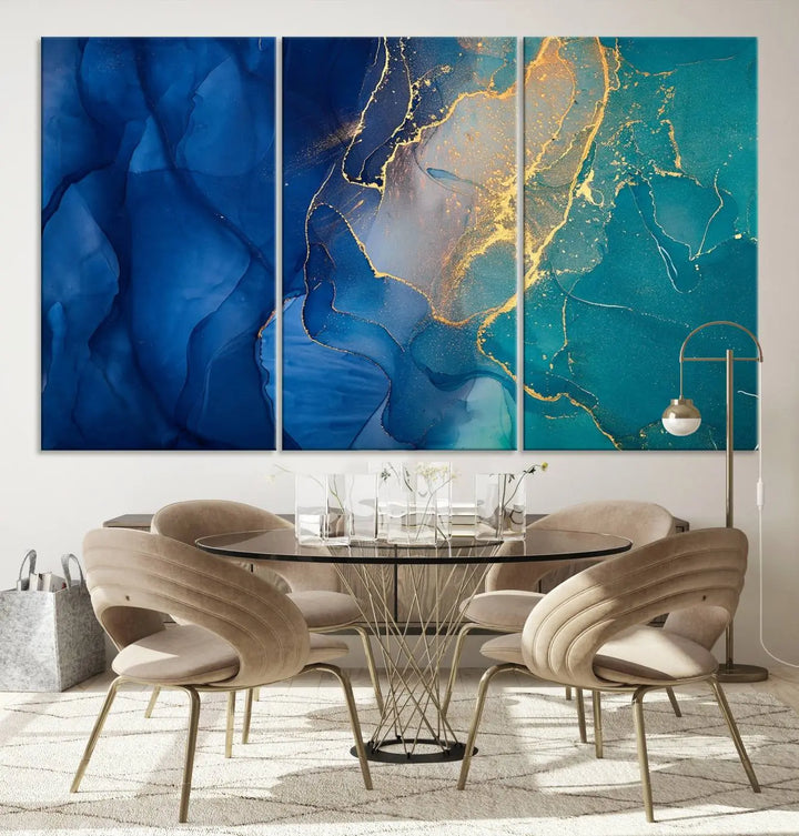 A Navy Blue and Green Marble Fluid Effect Wall Art Abstract Canvas Wall Art Print, featuring captivating patterns of blue and teal hues interlaced with gold veining, is ready to hang and protected by a UV-coating to preserve its vibrant colors over time.