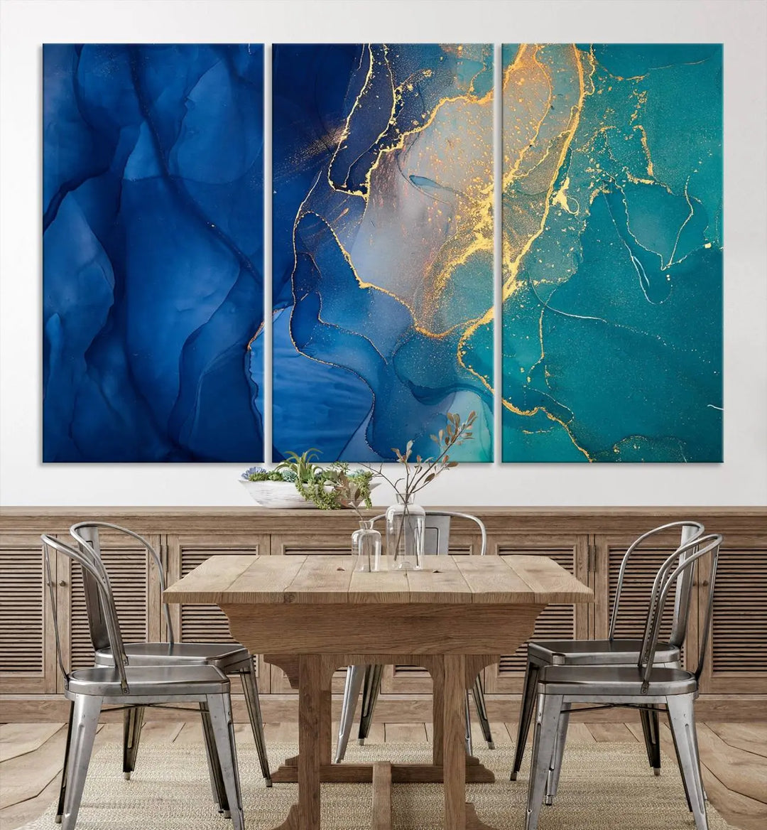 A Navy Blue and Green Marble Fluid Effect Wall Art Abstract Canvas Wall Art Print, featuring captivating patterns of blue and teal hues interlaced with gold veining, is ready to hang and protected by a UV-coating to preserve its vibrant colors over time.