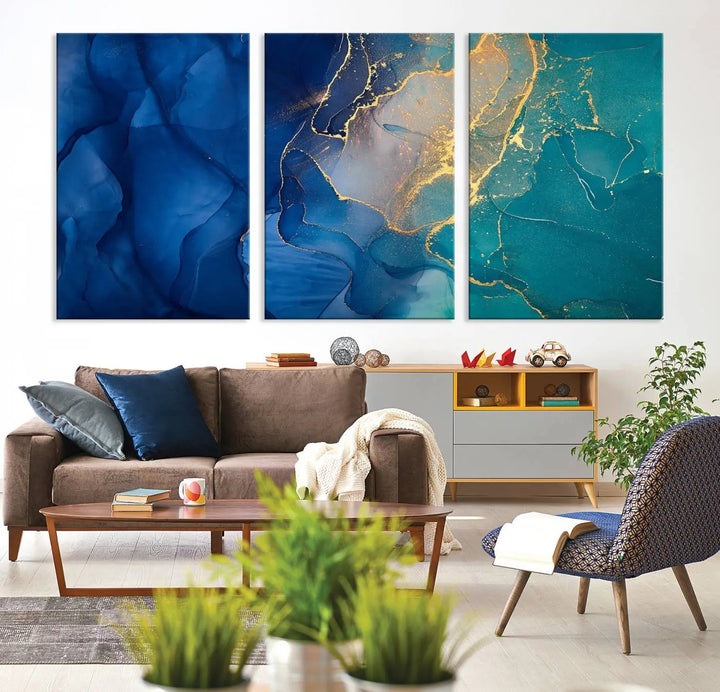 A Navy Blue and Green Marble Fluid Effect Wall Art Abstract Canvas Wall Art Print, featuring captivating patterns of blue and teal hues interlaced with gold veining, is ready to hang and protected by a UV-coating to preserve its vibrant colors over time.