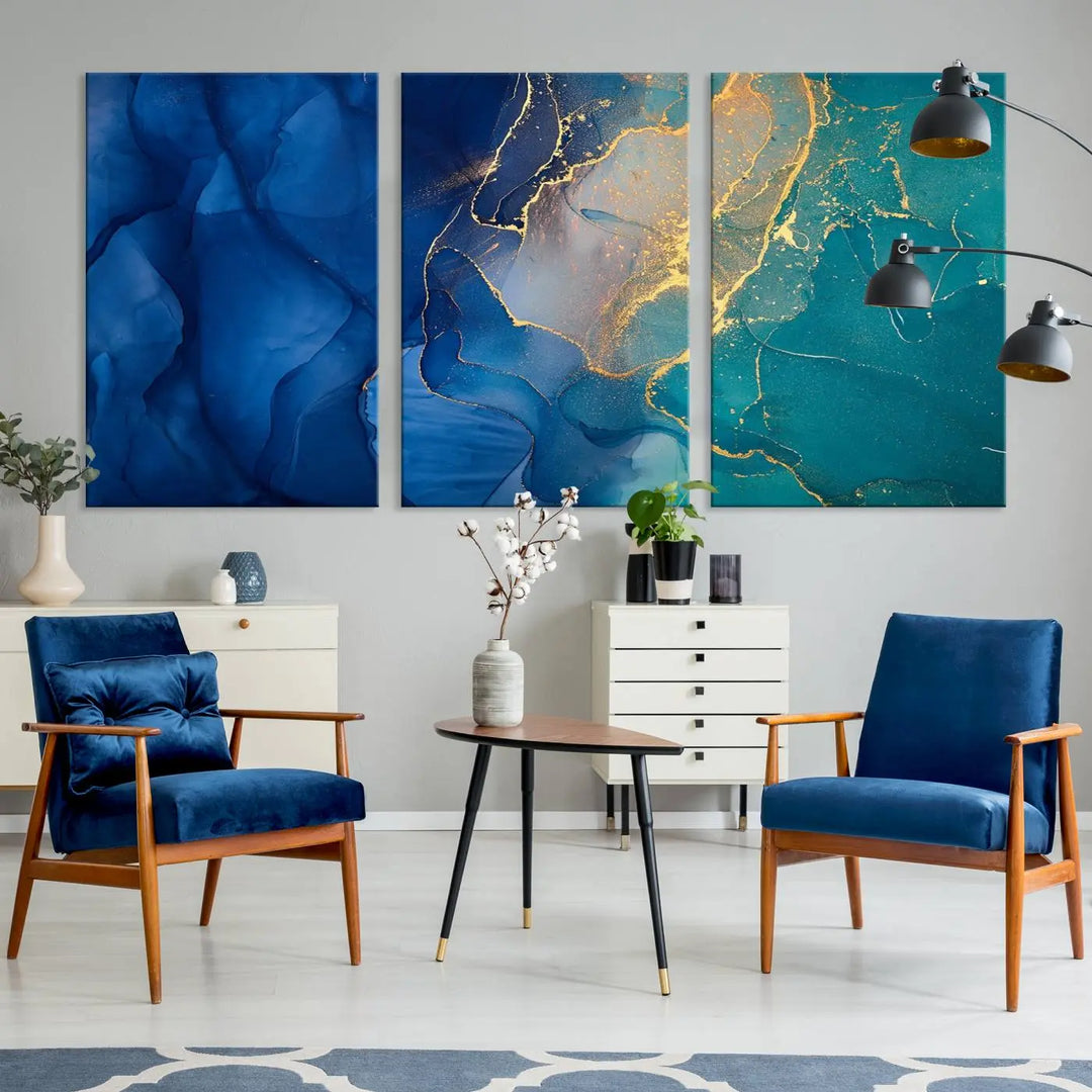 A Navy Blue and Green Marble Fluid Effect Wall Art Abstract Canvas Wall Art Print, featuring captivating patterns of blue and teal hues interlaced with gold veining, is ready to hang and protected by a UV-coating to preserve its vibrant colors over time.