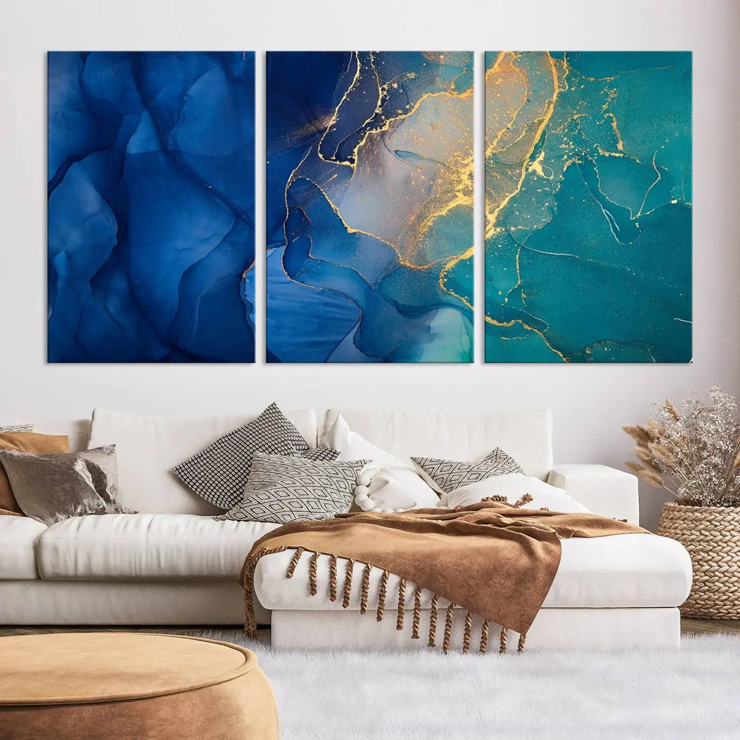 A Navy Blue and Green Marble Fluid Effect Wall Art Abstract Canvas Wall Art Print, featuring captivating patterns of blue and teal hues interlaced with gold veining, is ready to hang and protected by a UV-coating to preserve its vibrant colors over time.