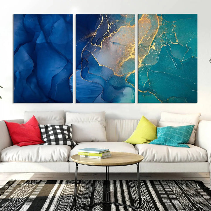 A Navy Blue and Green Marble Fluid Effect Wall Art Abstract Canvas Wall Art Print, featuring captivating patterns of blue and teal hues interlaced with gold veining, is ready to hang and protected by a UV-coating to preserve its vibrant colors over time.